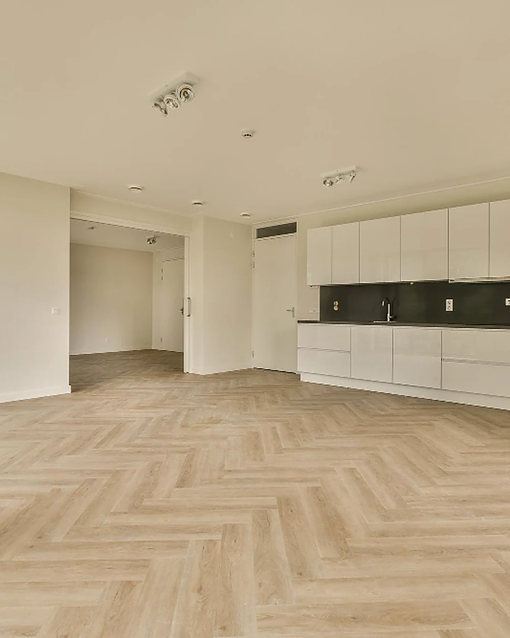 Finished herringbone laminate flooring in an open-plan room